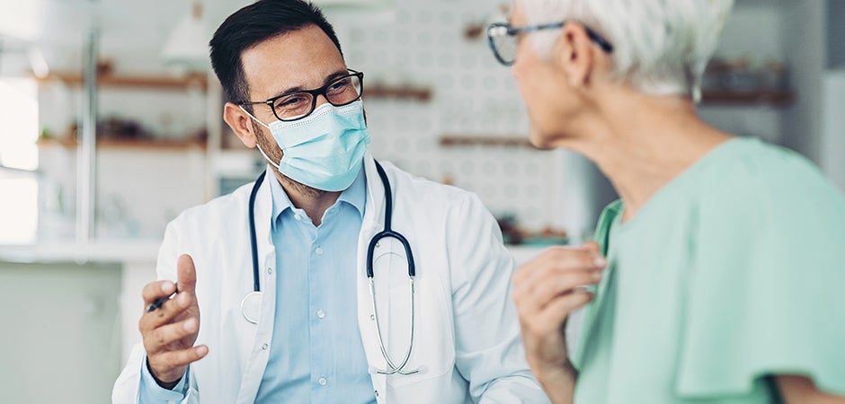 Primary Care Doctor Speaking with Elderly Patient