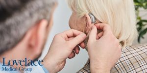 A patient gets fitted with a new hearing aid.